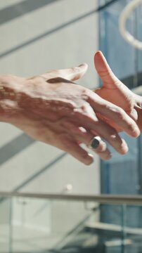 Business, people and meeting with handshake in office building for introduction or partnership. Closeup, employees or colleagues shaking hands for greeting, agreement or deal together in workplace