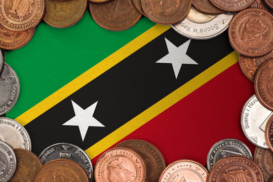Coins on flag of Saint Kitts and Nevis trading investment business currency concept

