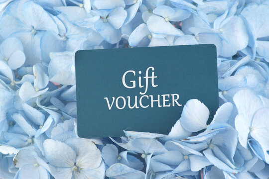 Blue Gift Card with flowers on a light background