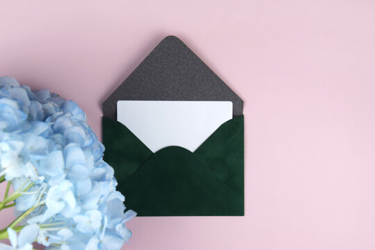 Gift voucher in a green envelope on a light background
