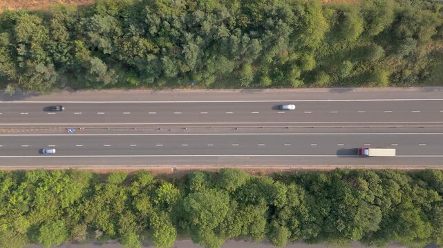 Aerial Birds Eye view looking down on traffic on the M54 motorway as the cars, vans and trucks cross the scene