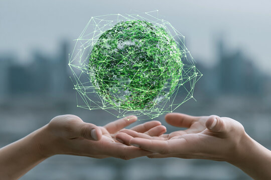 Two human hands gently cradle a glowing digital globe composed of green foliage and intricate light networks symbolizing sustainability technology and global environmental care