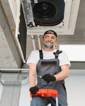 Hvac technician installing air conditioner system