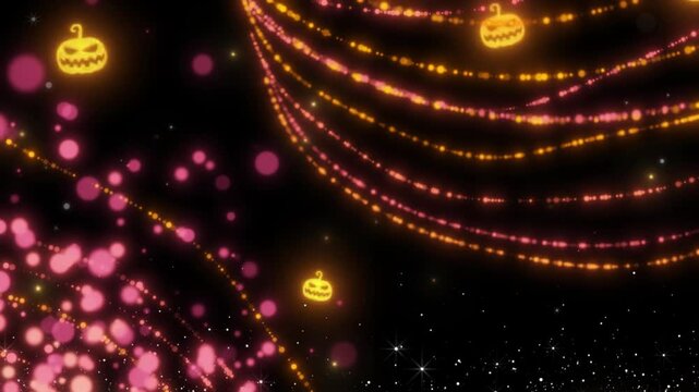Halloween pumpkins glow as golden lights hang suspended in the dark night sky for a festive scene.