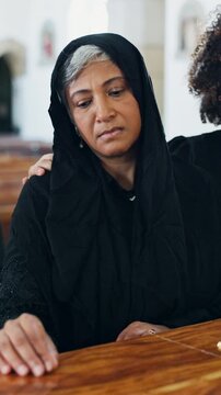 Sad, old woman and comfort at funeral with coffin, condolences or memorial service for deceased. Family, console and senior widow with casket at church, final goodbye and burial for farewell ceremony