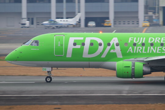 Fuji Dream Airlines (FDA) Embraer E175 taxiing in green livery on January 11, 2016 in Aso Kumamoto Airport, Japan.