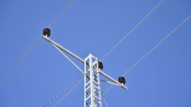 Medium Voltage Power Distribution Lines with Ceramic Insulators Against Blue Sky | Electrical Infrastructure 4K Video