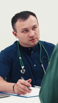 Physician meeting with a patient in a modern clinic. Concept primary healthcare, patient examination, doctor consultation, medical care, healthcare services.