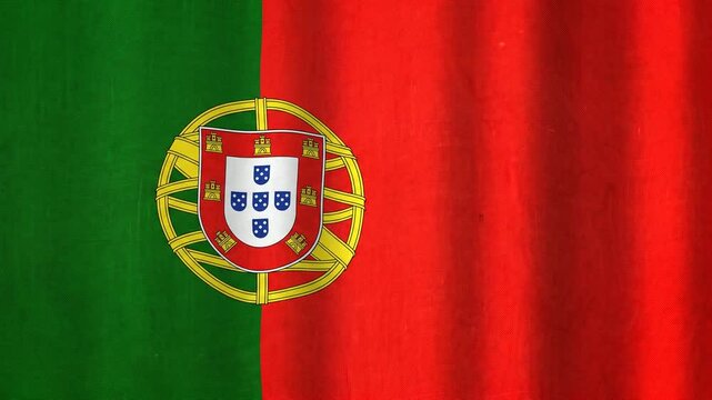 The national flag of Portugal waves with a soft motion, displaying its vibrant red and green colors and central emblem.