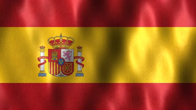 The national flag of Spain ripples gently in the breeze, displaying its distinct red and yellow colors and central coat of arms.