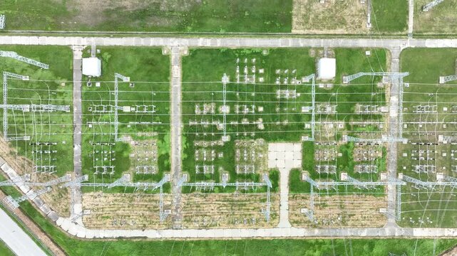 Aerial view of an electrical substation and high-voltage power lines. Energy grid infrastructure, symbolizing the transition to renewable power.