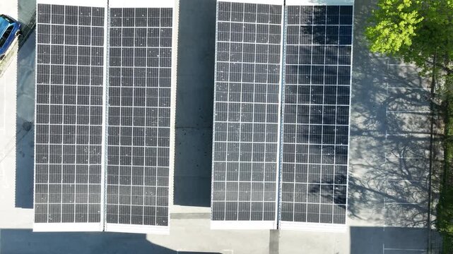 Aerial Top-Down View of Solar Panels on a Parking Lot Carport, Generating Clean Renewable Energy in an Urban Environment