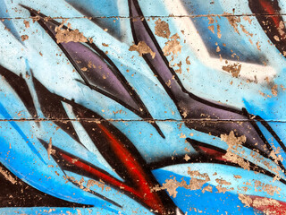 Abstract blue and black shapes paint on textured weathered surface © Aryo
