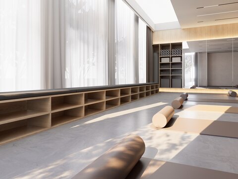 Empty yoga studio with mats and bolsters ready for restorative class