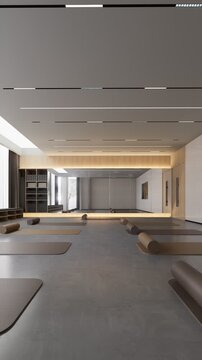 Empty modern yoga room with mats and foam rollers ready for use