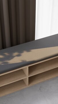 Sunlit bench in empty yoga studio with shadows on fabric cushion