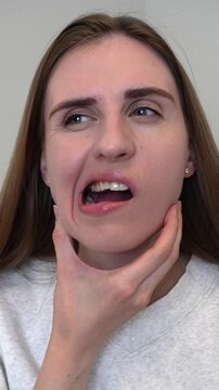 Young woman experiencing jaw pain and facial discomfort.