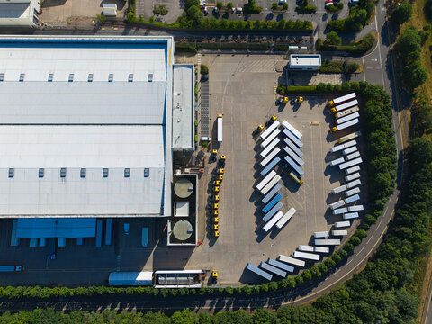 Aerial View of Modern Factories and Distribution Warehouses with HGVs in UK