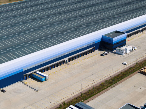Aerial View of Modern Factories and Distribution Warehouses with HGVs in UK