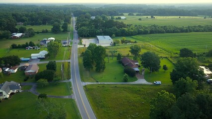Early morning in Tennessee countryside with country road and homes in rural America beside green pastures and farmland © Steve Tanner Stock