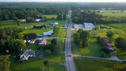 Early morning in Tennessee countryside with country road and homes in rural America beside green pastures and farmland © Steve Tanner Stock