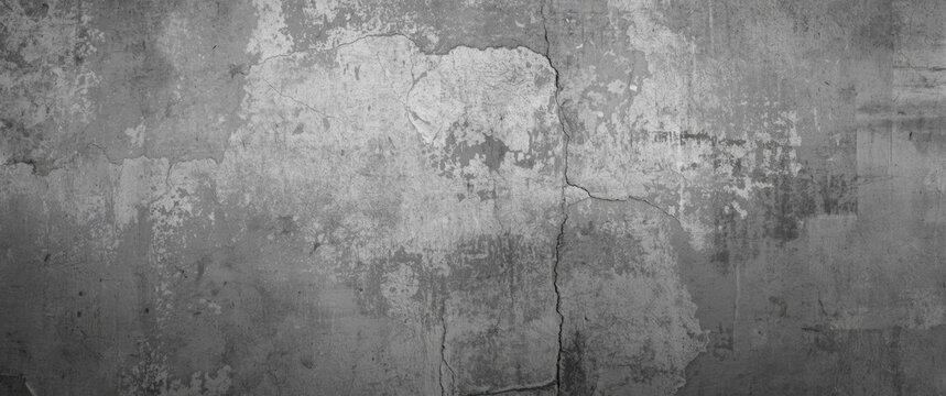 Textured gray concrete wall with cracks and wear