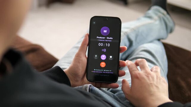 Smartphone screen glows with an active casting call from a film producer. Interface shows speaker and keypad options, indicating a live connection. Captures the pivotal moment of answering a life