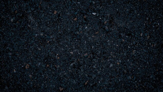 Black Gravel Texture with Small Rocks and Granules in Dark Lighting