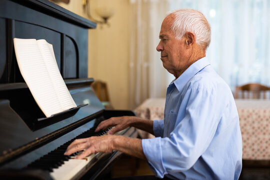 Compositor creating new music with piano at home
