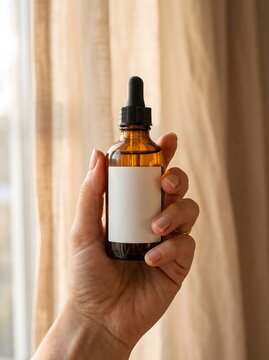 Hand Presenting Blank Serum Bottle Mockup in Warm Luxury Spa Interior