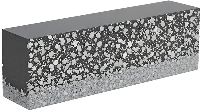 A close-up of a concrete block with exposed aggregate texture on a neutral background.
