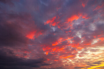 Fototapeta premium Partly cloudy sunset sky. Dramatic orange sky background.