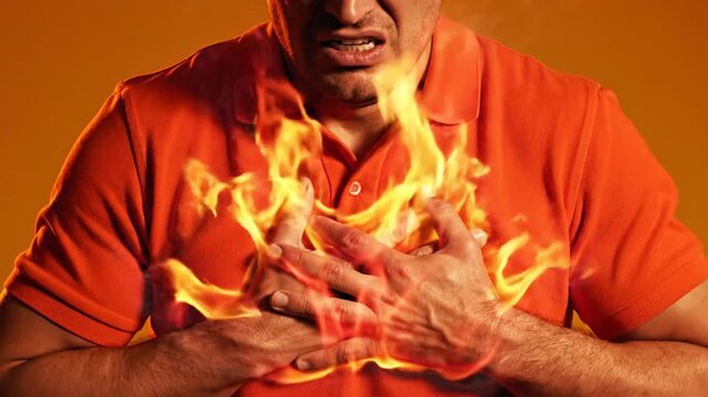 Man clutching his chest with dramatic fire effect, symbolizing heartburn, chest pain, acid reflux, heart attack risk, emergency healthcare, medical concept, and health awareness.