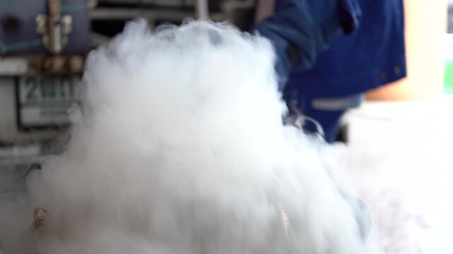 Close-up of thick white vapor rising from a container of liquid nitrogen.