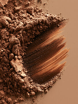 Brown Cosmetic Powder and Dark Makeup Brush Stroke on Beige Background for Beauty Product Advertising