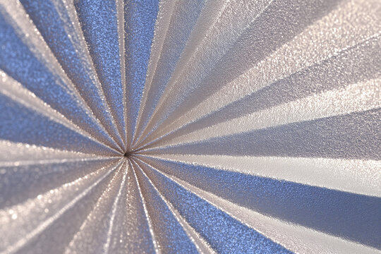 Macro Abstract Silver and Blue Radial Metallic Texture with Shimmering Folds for Futuristic Background Design
