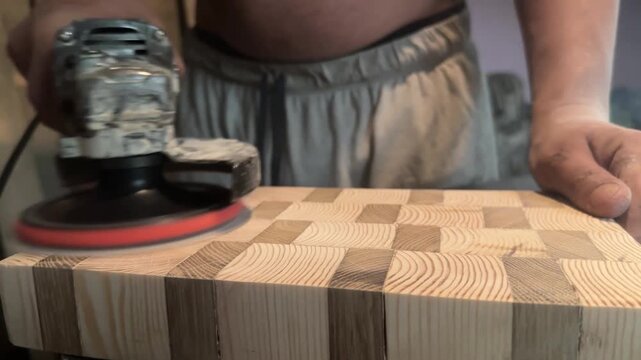 Sanding an end-grain kitchen cutting board. High quality 4k footage