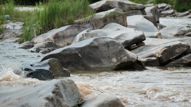 Dirty river after rain. strong flow of mountain river. rise in water level after rainfall. flood, natural disaster, mountain river