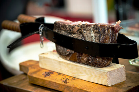 Traditional Prosciutto Ham Holder Clamp Stand on Wooden Cutting Board