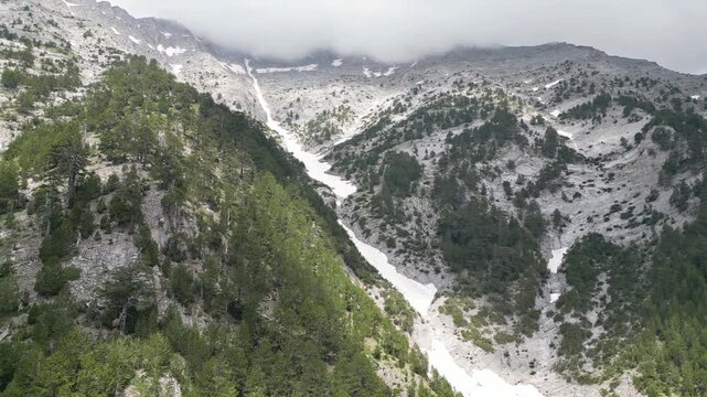 Drone Flying Along Snow Gully Toward Zonaria on Mount Olympus, Greece