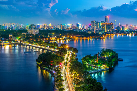 Panoramic night cityscape of Hanoi with Thanh Nien street light trails and West Lake
