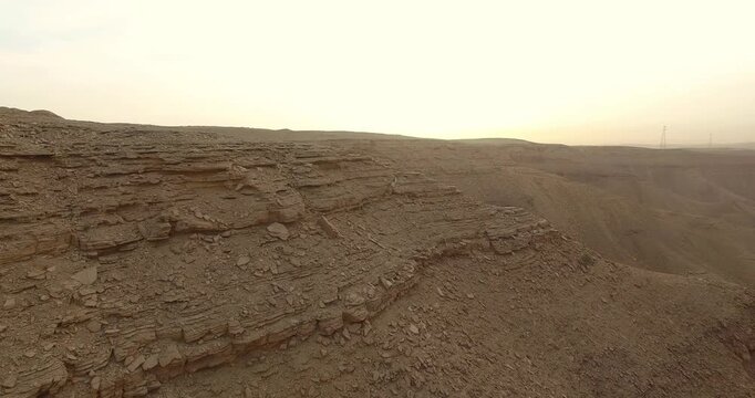 drone video of rugged desert mountain canyon and rocky terrain, forward slow movement revealing arid landscape Saudi Arabia Riyadh
