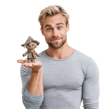 Handsome Blonde Man Holding Small Scarecrow Toy on Palm isolated on transparent or white background, png