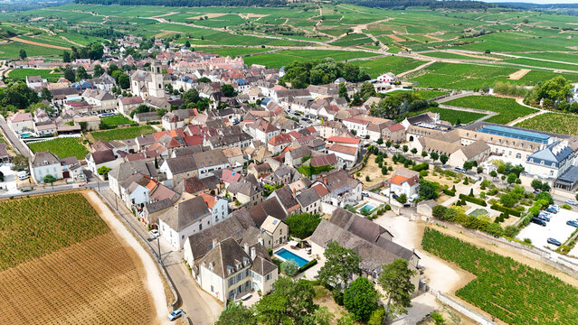 Aerial view of Pommard, Burgundy, France, with Pinot Noir vineyards, wine production, viticulture, agriculture, and a historic village surrounded by vineyards.