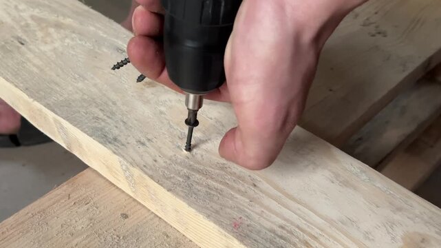 fastening wooden boards with a self-tapping screw . High quality 4k footage