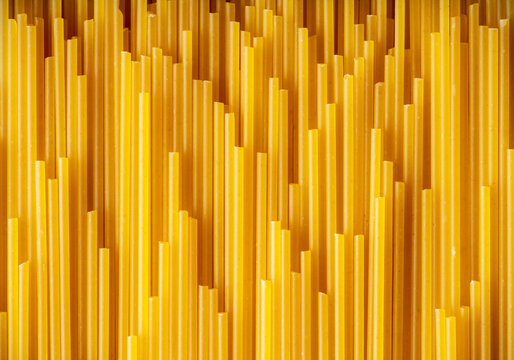 Dry spaghetti as textured background. Shot from above. Background and textures.