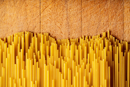 Dry spaghetti as textured background. Shot from above. Background and textures.