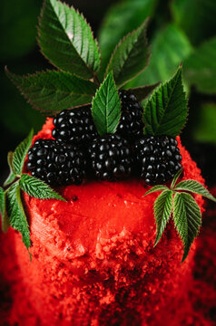 Red blackberry cake on dark wooden background. Selective focus.