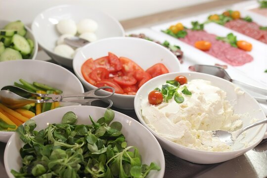 Healthy Breakfast Buffet with Fresh Cream Cheese, Tomatoes, Salad Greens, Eggs, Cucumbers, Vegetables and Cold Cuts. Self Service Hotel Food Bar. Catering, Brunch, Hospitality Dining. Selective focus