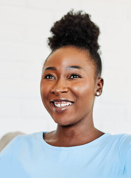 Portrait of a young happy black woman posing at home or in the office